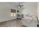 Cozy bedroom features a crib, a window with blinds, and wood-look flooring at 4446 W Hower Rd, Phoenix, AZ 85086