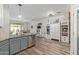 Modern kitchen with light countertops, stainless appliances, and hardwood floors leading to dining at 4446 W Hower Rd, Phoenix, AZ 85086