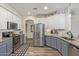 Modern kitchen featuring stainless steel appliances, two-tone cabinets, and wood-look tile flooring at 4446 W Hower Rd, Phoenix, AZ 85086