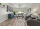Comfortable living room features a large gray sectional, wood floors, and plenty of natural light at 4446 W Hower Rd, Phoenix, AZ 85086