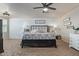 Lovely bedroom featuring a king-sized bed, carpet floors, shiplap wall and decor at 4446 W Hower Rd, Phoenix, AZ 85086