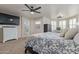 Cozy bedroom with a king-sized bed, neutral walls, carpet floors, ceiling fan and decor at 4446 W Hower Rd, Phoenix, AZ 85086