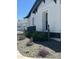 White and dark stone exterior with drought-resistant landscaping at 20475 E Indiana Ave, Queen Creek, AZ 85142