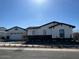 Single-story home with a detached garage, black trim, and desert landscaping at 20475 E Indiana Ave, Queen Creek, AZ 85142