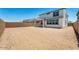 A large, empty backyard with a covered porch provides ample space for activities at 25238 N 172Nd Ln, Surprise, AZ 85378