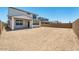 A large, empty backyard with a covered porch provides ample space for activities at 25238 N 172Nd Ln, Surprise, AZ 85378