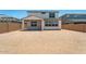A large, empty backyard with a covered porch provides ample space for activities at 25238 N 172Nd Ln, Surprise, AZ 85378