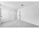 Bright bedroom with neutral carpet, white walls, and closet space at 25238 N 172Nd Ln, Surprise, AZ 85378