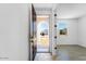 Bright entryway with light wood floors and a view to the front yard at 25238 N 172Nd Ln, Surprise, AZ 85378