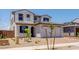 Charming two-story home featuring a tile roof, arched doorway, and a two-car garage at 25238 N 172Nd Ln, Surprise, AZ 85378