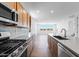 Kitchen with stainless steel appliances, stylish backsplash, and island overlooking living room at 25238 N 172Nd Ln, Surprise, AZ 85378