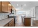 Kitchen with stainless steel appliances, stylish backsplash, and island overlooking living room at 25238 N 172Nd Ln, Surprise, AZ 85378