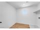 Spacious laundry room with wood flooring, utility sink, and shelving at 25238 N 172Nd Ln, Surprise, AZ 85378