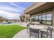Beautiful backyard features a pool, spa, turf, and a modern outdoor dining and lounge area at 37200 N Cave Creek Rd # 1023, Scottsdale, AZ 85262