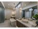 Lavish bathroom with a standalone tub, double vanities, and modern lighting, creating a spa-like ambiance at 37200 N Cave Creek Rd # 1023, Scottsdale, AZ 85262