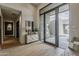 Bright foyer with hardwood floors, natural light, and a view of the landscaped courtyard, creating a serene entrance at 37200 N Cave Creek Rd # 1023, Scottsdale, AZ 85262