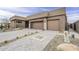 Contemporary home featuring a two-car garage, desert landscaping, and a paver driveway, highlighting modern curb appeal at 37200 N Cave Creek Rd # 1023, Scottsdale, AZ 85262