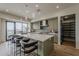 Modern kitchen featuring a large island with bar seating, sleek cabinetry, and contemporary lighting at 37200 N Cave Creek Rd # 1023, Scottsdale, AZ 85262