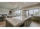 Open concept kitchen featuring a large island, stainless appliances, hardwood floors and a view to the outdoor patio at 37200 N Cave Creek Rd # 1023, Scottsdale, AZ 85262