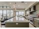 Modern kitchen featuring a long island, stainless steel appliances, and large windows offering plenty of natural light at 37200 N Cave Creek Rd # 1023, Scottsdale, AZ 85262
