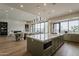 Open concept kitchen featuring a large island, stainless appliances, hardwood floors and a view to the outdoor patio at 37200 N Cave Creek Rd # 1023, Scottsdale, AZ 85262