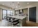 Modern kitchen with an oversized island with seating, stainless appliances and light green cabinetry at 37200 N Cave Creek Rd # 1023, Scottsdale, AZ 85262