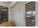 Kitchen featuring custom cabinetry, stainless steel appliances, wine storage and adjacent pantry at 37200 N Cave Creek Rd # 1023, Scottsdale, AZ 85262