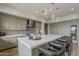 Modern kitchen featuring white countertops, an island with seating, stainless appliances and light green cabinets at 37200 N Cave Creek Rd # 1023, Scottsdale, AZ 85262