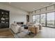Bright living room with high ceilings, a modern fireplace, and expansive windows, perfect for comfortable and stylish living at 37200 N Cave Creek Rd # 1023, Scottsdale, AZ 85262