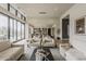 Bright living space featuring hardwood floors, neutral furniture, and expansive glass doors leading to pool at 37200 N Cave Creek Rd # 1023, Scottsdale, AZ 85262