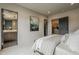Modern main bedroom featuring neutral tones, ensuite bathroom, and sleek doorways at 37200 N Cave Creek Rd # 1023, Scottsdale, AZ 85262