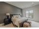 A neutral-toned main bedroom features a large window, an elegant bed, and comfortable seating at 37200 N Cave Creek Rd # 1023, Scottsdale, AZ 85262