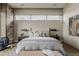 Well-lit main bedroom with a stone accent wall, plush bedding, and a view of the outdoor scenery at 37200 N Cave Creek Rd # 1023, Scottsdale, AZ 85262