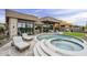 Stunning pool and spa area features lounge chairs and a seamless design with the home's architecture at 37200 N Cave Creek Rd # 1023, Scottsdale, AZ 85262