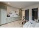 Sitting room features a green cabinet wall, a modern sofa and sliding barn door to the ensuite at 37200 N Cave Creek Rd # 1023, Scottsdale, AZ 85262