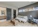 Sitting area with a grey accent wall, modern sofa, and sliding barn door to the ensuite at 37200 N Cave Creek Rd # 1023, Scottsdale, AZ 85262