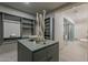 Spacious walk-in closet featuring custom shelving, drawers, and a view of the bathroom and shower at 37200 N Cave Creek Rd # 1023, Scottsdale, AZ 85262