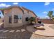 Well-maintained backyard with brick patio and built-in fire pit, perfect for entertaining guests at 44032 W Garden Ln, Maricopa, AZ 85139