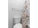 Bathroom featuring a toilet and bathtub-shower combination with a floral shower curtain at 44032 W Garden Ln, Maricopa, AZ 85139