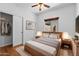 Bedroom featuring a bed, window, ceiling fan, and closet with sliding doors at 44032 W Garden Ln, Maricopa, AZ 85139