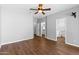 Bright bedroom with wood floors, ceiling fan, and ample closet space for organized living at 44032 W Garden Ln, Maricopa, AZ 85139