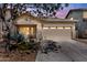Charming single-story home featuring a neutral stucco exterior, a two-car garage, and desert landscaping at 44032 W Garden Ln, Maricopa, AZ 85139