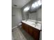 Bright bathroom with dual sinks, granite counters, and ample cabinet storage space at 1302 W Estrella Dr, Chandler, AZ 85224