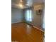 Comfortable bedroom with wood floors and a large window providing natural light at 1302 W Estrella Dr, Chandler, AZ 85224