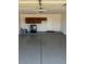 Spacious garage with epoxy flooring, laundry area, and wall storage at 1302 W Estrella Dr, Chandler, AZ 85224