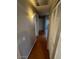 Hallway with wood floors and closet with ample storage leading to other rooms at 1302 W Estrella Dr, Chandler, AZ 85224