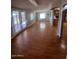 Open-concept living area with wood flooring, abundant natural light, and access to kitchen at 1302 W Estrella Dr, Chandler, AZ 85224