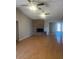 Spacious living room with a cozy brick fireplace and sleek ceiling fans at 1302 W Estrella Dr, Chandler, AZ 85224