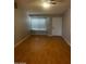 Inviting living area featuring wood floors and a bright window, perfect for relaxing at 1302 W Estrella Dr, Chandler, AZ 85224