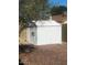 Backyard view of a small shed sitting on a gravel surface at 1302 W Estrella Dr, Chandler, AZ 85224